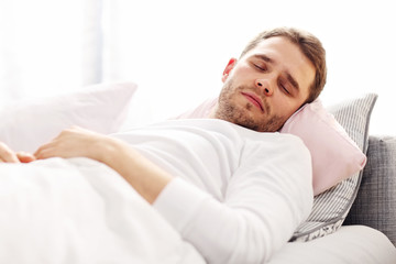 Young man sleeping in bed