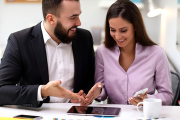 Businesspeople working together in office with tablet