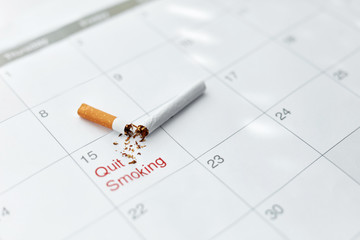 Quit Smoking. Close Up Of Broken Cigarette Lying On Calendar