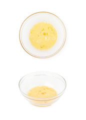 Whisked eggs in a glass bowl isolated