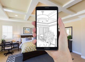 Hand Holding Smart Phone Displaying Drawing of Custom Bedroom Photo Behind.