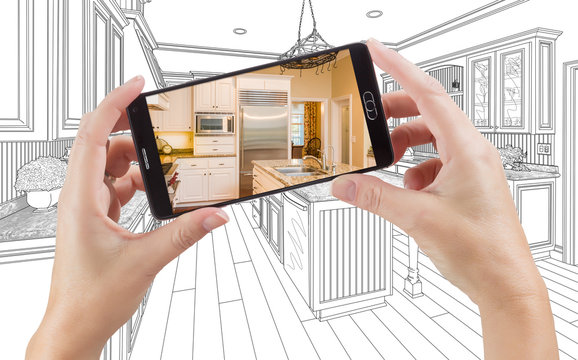 Hands Holding Smart Phone Displaying Photo of Custom Kitchen Drawing Behind.