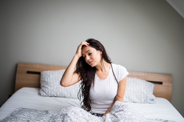 Young woman feel  sick and unwell on bed