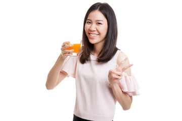Young Asian woman show victory sign drink orange juice.