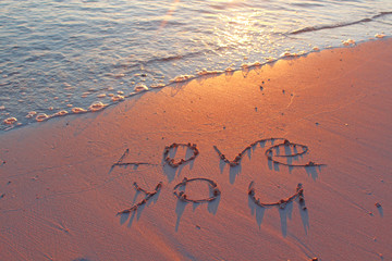 Sunset on the beach with Love You sign 