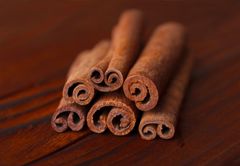 Aromatic cinnamon sticks on a wooden background