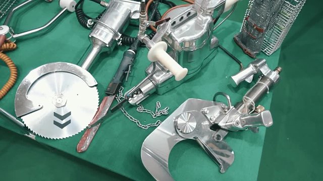 Shiny and powerful hand-held industrial devices for butchering animals and chopping bones and cut meat. Shot in motion