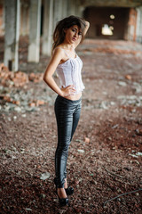 Portrait of young cute brunette girl wearing on black leather pa