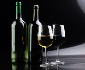 Wine glass and Bottle on black background. Red and white wine