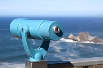 Telescope mounted on cliff overlooking Pacific coast along northern California.