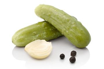 pickles with onion and black pepper on white background with shadow reflection. Cucumbers on white background.