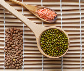 Mung beans and two kinds of lentils on a bamboo mat.