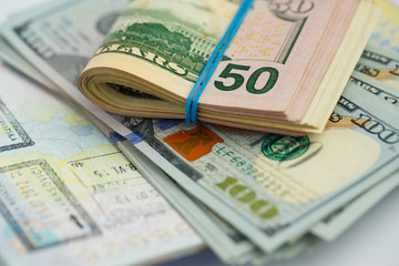 American money is on the top of the opened passport