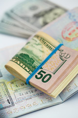 American money is on the top of the opened passport