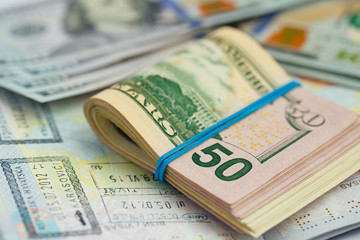 American money is on the top of the opened passport