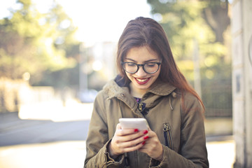 Girl with lipstick smiles at phone 