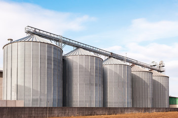 Agricultural silos on blue sky.