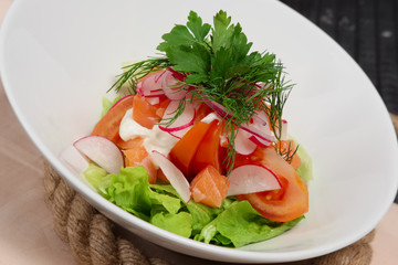 salad with radish, tomato, onion and salmon