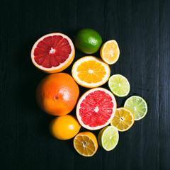 Fresh citrus stihli. Lemons, limes, grapefruit and orange on a black background - 134989360