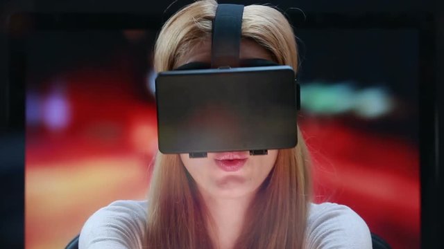 Car simulator using virtual reality technology. Girl with pleasure uses head-mounted display.