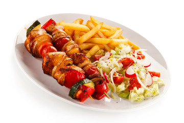 Kebabs - grilled meat and vegetables on white background 