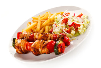 Kebabs - grilled meat and vegetables on white background 