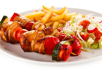 Kebabs - grilled meat and vegetables on white background 
