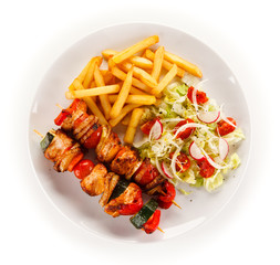 Kebabs - grilled meat and vegetables on white background 