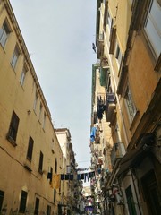Fototapeta na wymiar NAPLES, ITALY - JANUARY 28, 2017 : street view of old city center of Naples with clothes hanged in the street.