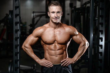 Fototapeta na wymiar Handsome fitness model train in the gym gain muscle