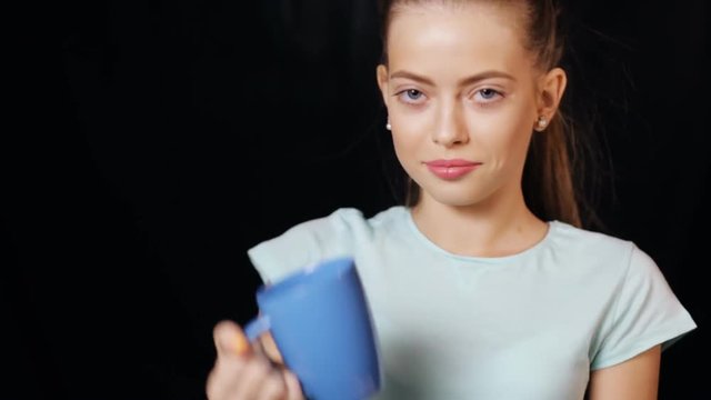 Teen girl drinking tea from empty cup
