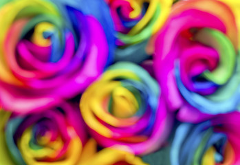 Fototapeta na wymiar Blurry image of rainbow roses. Postcard for Valentine's and Mother's day
