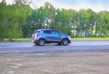 Obraz na płótnie Canvas SUV moves on the highway