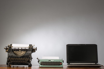 Vintage typewriter and laptop. New and old typing machines.