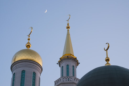 Crescent moon over the domes and minarets of the Moscow Cathedral Mosque in the spring twilight