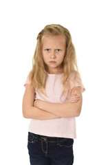 sweet young schoolgirl with blond hair and folded arms angry upset frustrated and unhappy