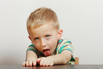 Kid making funny faces being bored