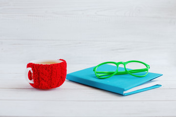 Book, glasses and a cup of tea on a white background. 