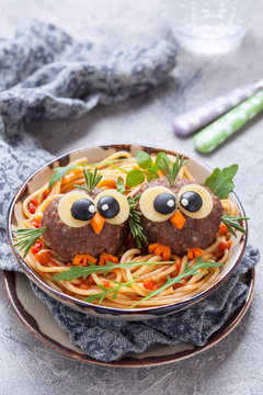 Pasta spaghetti with funny meatballs for kids