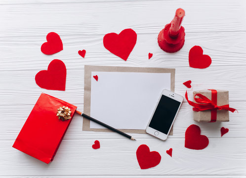 Valentine's Day. love letter,smart phone,felt heart  and decor on wooden background