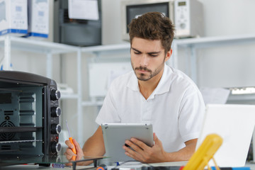 attractive repairman concentrated at work