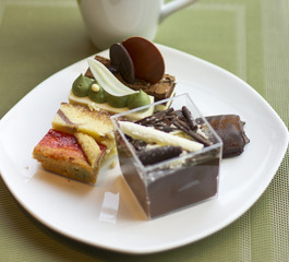 Dessert on a plate. Delicious sweet dessert. Refreshments. Souffle and cakes on a white plate
