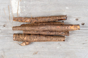 Group of black raw salsifies on wood