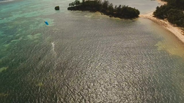 Kitesurfing on tropical island. Aerial view:kitesurfer sea rider rides at high speed through the waves. Kite surfing on a sunny day on a tropical island.Travel concept. Philippines, Boracay. 4K video