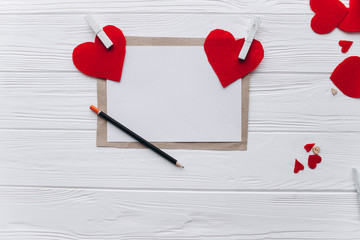 Valentine's Day. love letter, heart felt and decor on wooden background