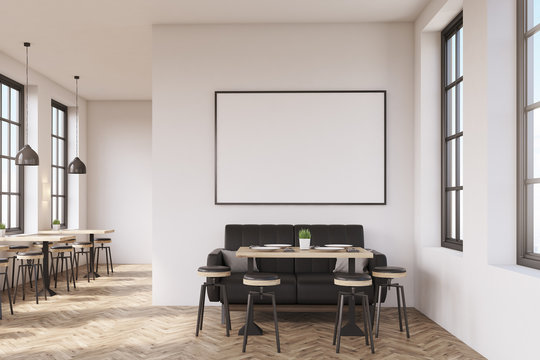 Coffee shop interior with a large sofa near a white wall, a row of tables with chairs near windows and a big horizontal poster on the wall, wooden floor. 3d rendering. Mock up.