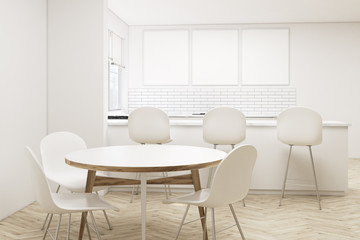 Kitchen with bar, round table and posters