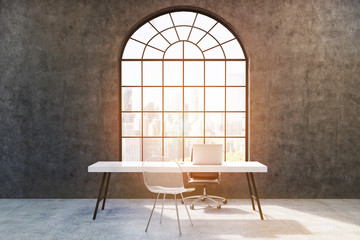 Home office with concrete walls, large window, white table with a laptop and a transparent chair near it. 3d rendering. Toned image