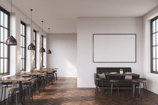 Cafe interior with a large sofa near a white wall, a row of tables with chairs near windows and a big horizontal poster on the wall. 3d rendering. Mock up.