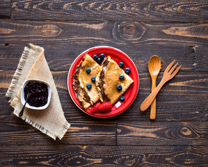 Fresh Strawberries Pancakes or Crepes with berries and chocolate